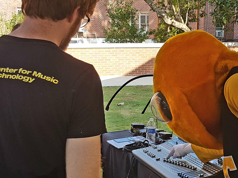 The Georgia Tech mascot Buzz checks out a sound board on display.